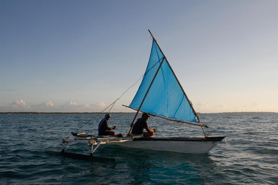 Men in boat off coast of Kiribati Men in boat off coast of Kiribati