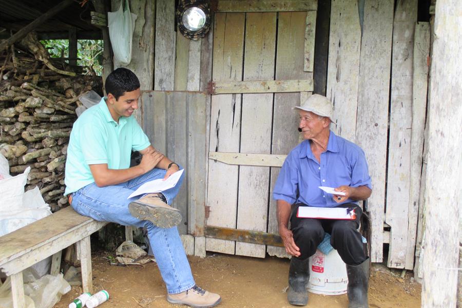 A coffee farmer answers survey questions as part of the CASCADE project. A coffee farmer answers survey questions as part of the CASCADE project.